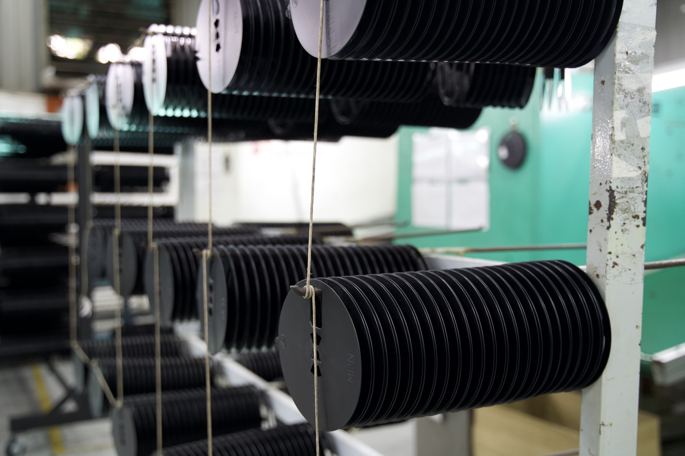Finished molded reels staged on Taipex shop-floor racks
